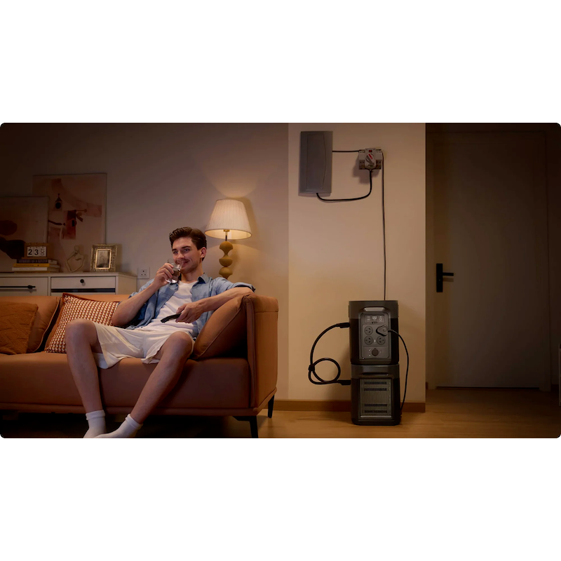 EcoFlow DELTA 2 Max powering essential home appliances during a blackout, with a man relaxing on a couch.