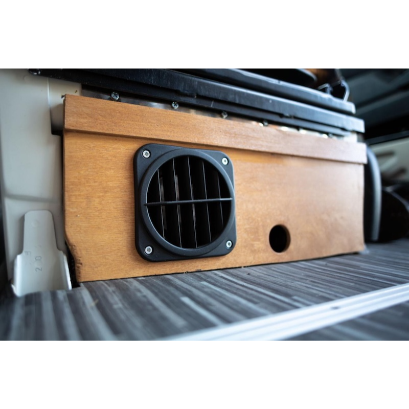 Warm air outlet vent installed in caravan cabinetry connected to diesel heater system.