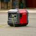 Honda EU30iS portable inverter generator operating outdoors with power cable connected