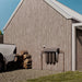 Puretec Hybrid E13 whole house rainwater filtration system installed on exterior wall connected to tank water supply